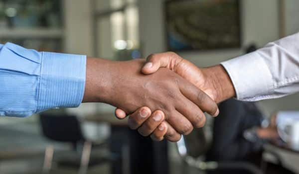 2 men shaking hands.