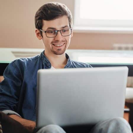a young man working on a computer.